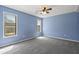 Serene blue bedroom with plenty of natural light from multiple windows and gray carpet at 201 Commons Way, Goose Creek, SC 29445
