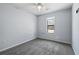 Bedroom with gray carpet, ceiling fan, and a window bringing in natural light at 201 Commons Way, Goose Creek, SC 29445