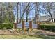 Charming entrance to The Commons community with a white picket fence and beautiful landscaping at 201 Commons Way, Goose Creek, SC 29445