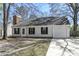 Quaint single-story home featuring a classic brick chimney, siding, and an attached one-car garage at 201 Commons Way, Goose Creek, SC 29445