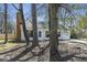 Charming home with a brick chimney, white siding, and a lovely treed front yard at 201 Commons Way, Goose Creek, SC 29445