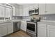 Modern kitchen featuring stainless steel appliances, light countertops, and ample storage at 201 Commons Way, Goose Creek, SC 29445