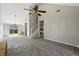 Bright and open living room with vaulted ceilings, laundry area, and a sliding door leading to the patio at 201 Commons Way, Goose Creek, SC 29445