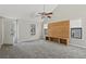 Spacious living room with vaulted ceilings, a modern ceiling fan, and a built-in wood entertainment center at 201 Commons Way, Goose Creek, SC 29445