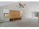 Bright and open living room with vaulted ceilings, a modern ceiling fan, and a built-in wood entertainment center at 201 Commons Way, Goose Creek, SC 29445