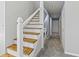 Modern staircase design with wooden steps, metal railings, and a view of laundry area at 201 Commons Way, Goose Creek, SC 29445