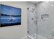 Marble-style tile work in shower with glass door and built-in shelf at 202 Basswood Ave, Summerville, SC 29483
