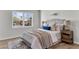 Bright bedroom featuring a large window, neutral walls, and a comfortable bed with stylish bedding and decor at 202 Basswood Ave, Summerville, SC 29483