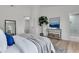 Cozy bedroom with a modern aesthetic, featuring sleek decor, a stylish console table, and an ensuite bathroom at 202 Basswood Ave, Summerville, SC 29483