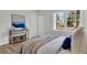 Bright bedroom featuring a large window, light wood flooring, and neutral decor at 202 Basswood Ave, Summerville, SC 29483