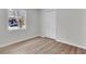 Minimalist bedroom with natural light, featuring wood-look flooring and a closet for storage at 202 Basswood Ave, Summerville, SC 29483