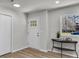 Bright entryway with a modern front door, wood floors, and neutral paint at 202 Basswood Ave, Summerville, SC 29483