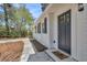 Inviting front entry with a dark blue door, and a charming hello mat at 202 Basswood Ave, Summerville, SC 29483