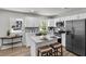 Modern kitchen featuring white cabinetry, a kitchen island, and stainless steel appliances at 202 Basswood Ave, Summerville, SC 29483