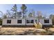 Charming single-story home boasting a welcoming entrance, well-manicured landscaping, and a serene setting at 2293 Old Hwy 6, Cross, SC 29436