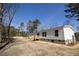 Exterior view showcasing a well-built home with a small deck and natural surroundings at 2293 Old Hwy 6, Cross, SC 29436