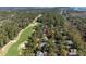 Magnificent aerial showcasing sprawling green golf course nestled among beautiful homes and trees at 2440 Cat Tail Pond Rd, Seabrook Island, SC 29455