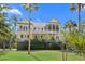 Rear exterior featuring upper and lower balconies, screened porch, and private, landscaped yard at 2440 Cat Tail Pond Rd, Seabrook Island, SC 29455