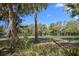 Expansive lawn with mature trees and scenic golf course views creates a relaxing outdoor setting at 2440 Cat Tail Pond Rd, Seabrook Island, SC 29455