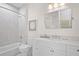 Bright bathroom featuring a tub/shower combo with white marble tile, vanity, and large mirrored wall cabinet at 2440 Cat Tail Pond Rd, Seabrook Island, SC 29455