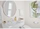 Well-lit bathroom featuring a classic sink, decorative mirror, and neutral color palette at 2440 Cat Tail Pond Rd, Seabrook Island, SC 29455