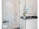 Marble tiled stand-up shower with glass door and modern vanity with dark countertops at 2440 Cat Tail Pond Rd, Seabrook Island, SC 29455