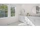 Elegant bathroom with white cabinetry, marble countertops, and natural light at 2440 Cat Tail Pond Rd, Seabrook Island, SC 29455
