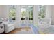 Cozy bedroom seating area with view of porch from French doors to balcony at 2440 Cat Tail Pond Rd, Seabrook Island, SC 29455