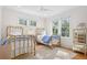 Bright bedroom featuring two twin gold-metal beds, neutral rug, and ample natural light from multiple windows at 2440 Cat Tail Pond Rd, Seabrook Island, SC 29455