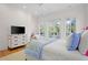Bedroom with balcony access, television, and neutral decor with ceiling fan at 2440 Cat Tail Pond Rd, Seabrook Island, SC 29455