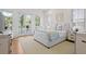 Bright bedroom with French doors to balcony, light yellow rug, and neutral decor at 2440 Cat Tail Pond Rd, Seabrook Island, SC 29455
