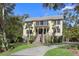 Stately two-story home boasts a charming front porch, upper balcony, and lush landscaping at 2440 Cat Tail Pond Rd, Seabrook Island, SC 29455