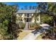 Beautiful two-story home with welcoming front porch, lush landscaping, and curving driveway at 2440 Cat Tail Pond Rd, Seabrook Island, SC 29455