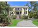 Welcoming front entrance features a brick staircase, a covered porch, and manicured landscaping at 2440 Cat Tail Pond Rd, Seabrook Island, SC 29455