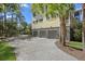 Spacious three-car garage with paved driveway, mature landscaping, and ample parking at 2440 Cat Tail Pond Rd, Seabrook Island, SC 29455