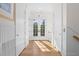 Bright hallway featuring hardwood floors, white doors, and French doors leading to the outside offering tons of natural light at 2440 Cat Tail Pond Rd, Seabrook Island, SC 29455