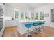 Bright kitchen with white cabinets, marble countertops, island with seating, and stainless steel appliances at 2440 Cat Tail Pond Rd, Seabrook Island, SC 29455