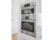Modern kitchen with stainless steel oven and microwave combination, along with stylish white cabinetry at 2440 Cat Tail Pond Rd, Seabrook Island, SC 29455