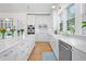 Beautiful white kitchen with marble counters, stainless steel appliances, and ample cabinet space at 2440 Cat Tail Pond Rd, Seabrook Island, SC 29455