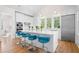 Bright kitchen featuring stainless steel appliances, a marble island with blue bar stools, and an open design at 2440 Cat Tail Pond Rd, Seabrook Island, SC 29455