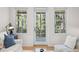 Cozy living room with comfortable seating, light hardwood floors, and a glass door leading to the outside at 2440 Cat Tail Pond Rd, Seabrook Island, SC 29455