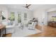 Bright living room with hardwood floors, neutral decor, and views of the trees at 2440 Cat Tail Pond Rd, Seabrook Island, SC 29455