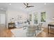 Sunlit living room with hardwood floors, comfortable seating, and bright windows offering tranquil views at 2440 Cat Tail Pond Rd, Seabrook Island, SC 29455