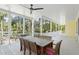 Covered porch with an outdoor dining table and chairs, offering views of the lush, tree-filled landscape at 2440 Cat Tail Pond Rd, Seabrook Island, SC 29455