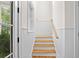 Staircase with wood treads, painted risers, and side window offering natural light at 2440 Cat Tail Pond Rd, Seabrook Island, SC 29455