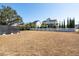 Large backyard featuring mature trees, white picket fence, and green space at 2545 Hatch Dr, Johns Island, SC 29455