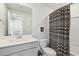 Bright bathroom with white vanity, patterned shower curtain, toilet and modern fixtures at 2545 Hatch Dr, Johns Island, SC 29455