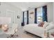 Bright bedroom features a bed, white walls and curtains with a view to the outdoors at 2545 Hatch Dr, Johns Island, SC 29455