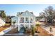 Charming two-story light blue home with a double front porch and well manicured landscaping at 2545 Hatch Dr, Johns Island, SC 29455