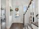 Bright foyer with wood floors, white staircase, and glass-paneled front door at 2545 Hatch Dr, Johns Island, SC 29455